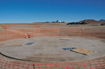 Figure 1. A concrete AOS antenna foundation cures. Cerro Chico is in the right foreground.