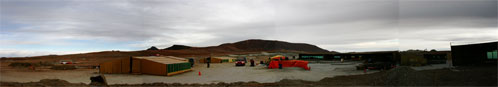Figure 2:  A panorama of construction at the Atacama Compact Array (ACA) site.  Concrete poured for foundations must be cured at a controlled temperature inside tented structures (center).  The ACA has 22 foundations and will be used for initial astronomical validation.
