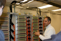 Figure 3: Backend lead Fabio Bincat-Matchet shows the newly completed fiber optic patch panel in the AOS Technical Building to members of the AAER panel.