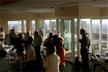 Figure 4: Members of the AAER Committee enjoyed dinner in the newly completed OSF Technical Building, including a panoramic view of the antennas: Vertex (right) and Melco (left) antennas.