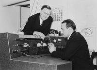 John D. Kraus at W8JK ham radio controls with Carroll Stegall watching