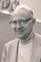 John D. Kraus in Ohio State classroom, helical antenna on wall in background