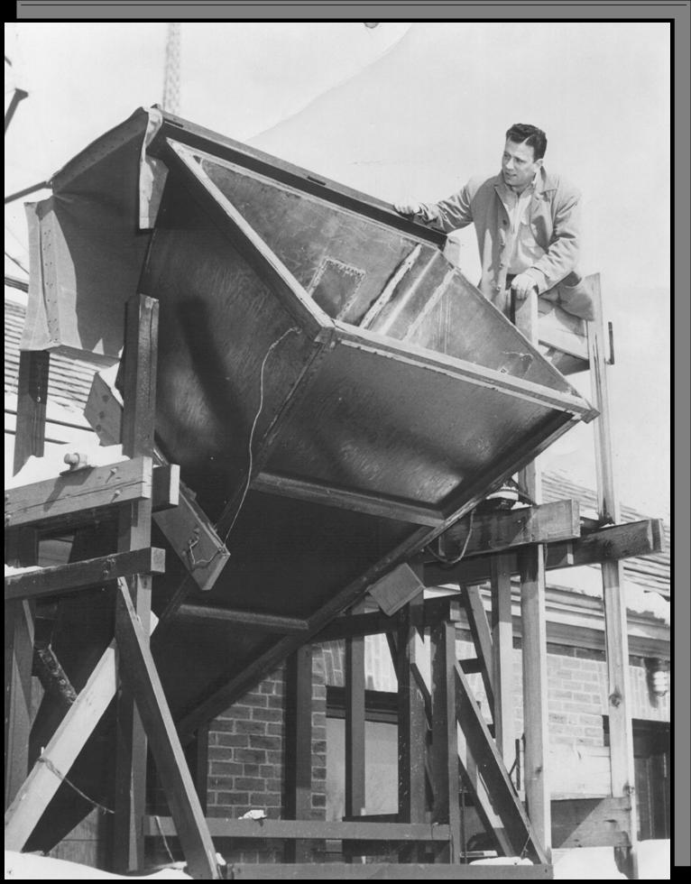 [Doc Ewen looking into the horn antenna]